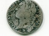 une vieille pièce de monnaie sur laquelle figure une tête de femme