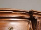 a close up of a wooden cabinet with a clock on it