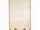 an old scroll hanging on a wall with a black hanger