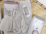 a basket with a hair dryer, hair brush, and other items on it