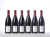 six bottles of red wine lined up in a row