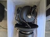 a white container with a bunch of headphones inside of it