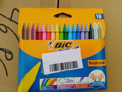 brightly colored crayons in a box with a price tag