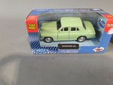 a green toy car in a box on a table