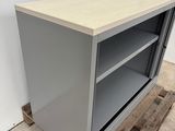 a grey metal cabinet with shelves and a wooden pallet