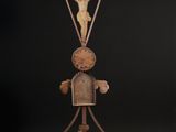 an old iron sculpture of a man holding a cross on a pole