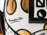 a close up of a coffee cup with a black and white design on it