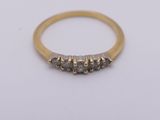 a yellow gold ring with three black diamonds on it