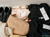 a pile of clothes and a purse sitting on a table