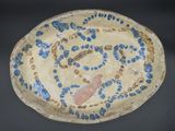 a blue and white plate with a fish design on it