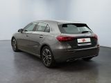 the rear of a silver mercedes cla parked in a room