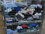 a large metal cart with a lot of clothes on top of it