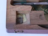 a wooden box with a pair of scissors inside of it