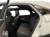 a white car with the door open and the passenger seat down