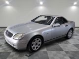 a picture of a silver mercedes slk parked in a garage