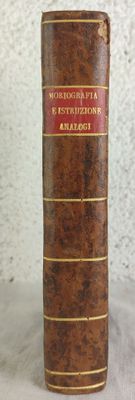 a close up of a brown book with a red stripe on it