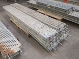 several pieces of metal are stacked on top of each other in a warehouse