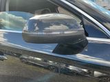 the side view mirror of a car with a cloudy sky in the background