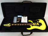 yellow electric guitar in a black case on a white surface