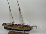 a small model of a boat on a wooden stand