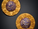 a pair of gold - plated and purple glass buttons