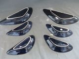 six black and silver car door handle covers on a table
