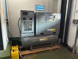 two air compressors sitting on a pallet in a garage