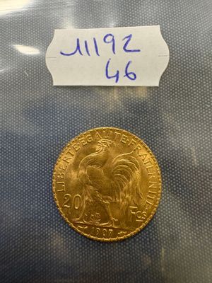 a close up of a gold coin with a label on it