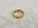 a close up of a gold ring with a green stone in the middle
