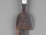 an image of a wooden comb with a carved design on it ' s side