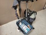a suitcase and a bag on the ground next to a bike