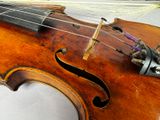 a close up of a violin with strings on it