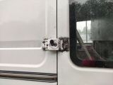 a close up of a door handle on a white van