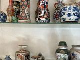 many different vases on the shelves in this room