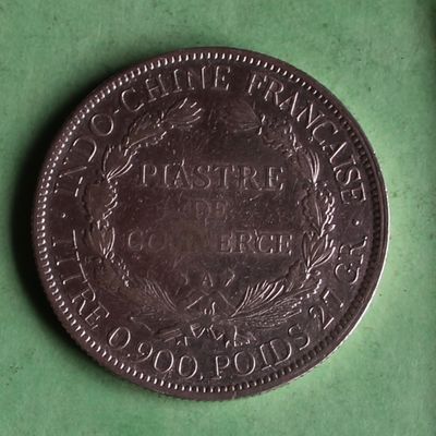 a close up of a coin on a green surface