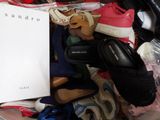 a pile of shoes and a book on a table