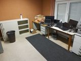 a room with a lot of desks and computers on it