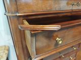 a wooden dresser with a drawer on top of it