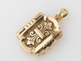 an 18k gold locke pendant with a cross on it