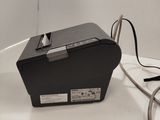 a black box sitting on a table with a cord attached to it