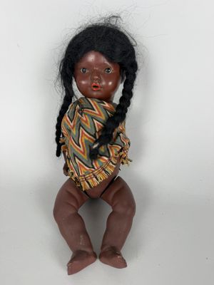 an image of a doll of a girl with black hair and braids
