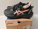 black and pink asics tennis shoes on top of a box