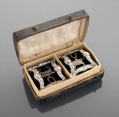 an image of a pair of silver cuff watches in a case