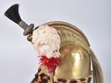 a stuffed animal that is sitting in a helmet
