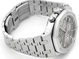 a close up of a watch on a white surface