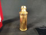 a small gold object sitting on a table next to a red box