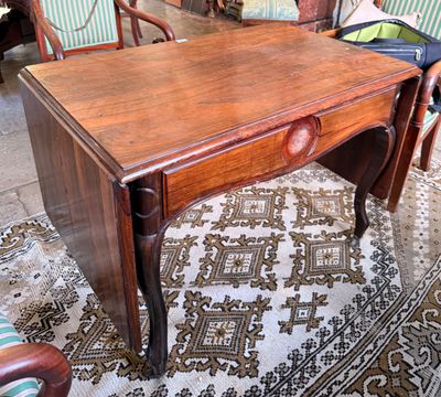a small wooden table with a drawer on top of it