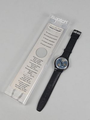 a watch that is sitting on a table next to a package