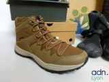 a pair of hiking boots and a pair of boots on a table