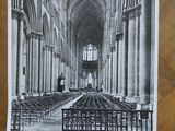 a black and white photo of a church with rows of pews
